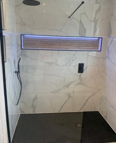Black slate effect tray with 600x1200 Carrara porcelain tile, black dual function concealed Vale, 800 wall hung unit and matching tall boy fitted in bathroom renovation project in Templeogue, Dublin by A&R Bathrooms