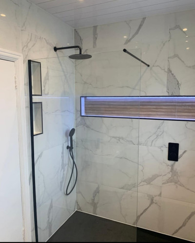 Black slate effect tray with 600x1200 Carrara porcelain tile, black dual function concealed Vale, 800 wall hung unit and matching tall boy fitted in bathroom renovation project in Templeogue, Dublin by A&R Bathrooms